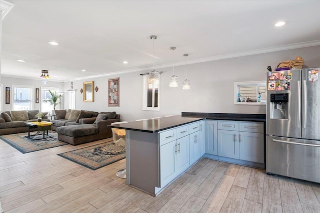31 Arthur St, Baldwin, NY 11510 - kitchen featuring a peninsula, stainless steel fridge, light wood-type flooring, and crown molding