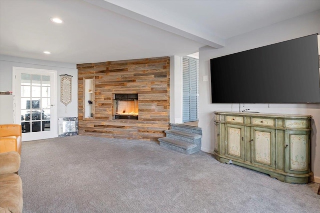 31 Arthur St, Baldwin, NY 11510 - unfurnished living room with recessed lighting, carpet floors, wood walls, and a stone fireplace