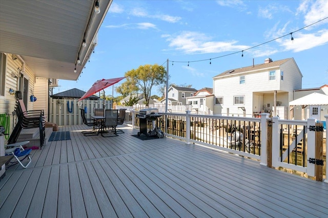 31 Arthur St, Baldwin, NY 11510 - deck with outdoor dining area, a grill, and a residential view