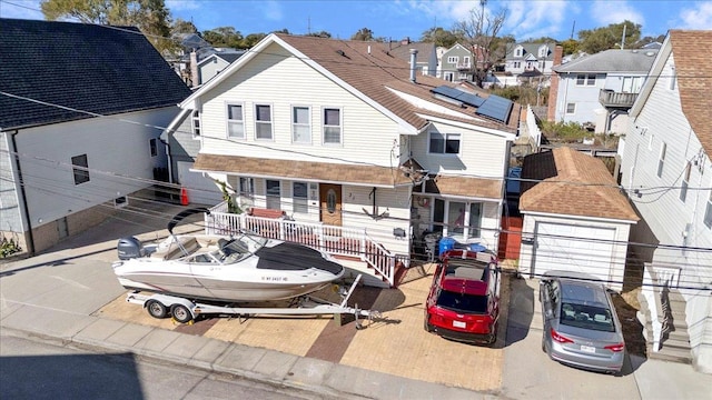 31 Arthur St, Baldwin, NY 11510 - view of front facade with a garage, a residential view, and covered porch