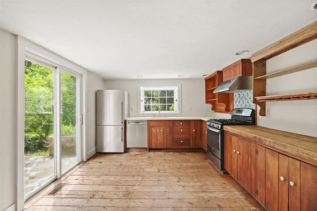 100 E St, South Salem, NY 10590 - kitchen with appliances with stainless steel finishes, open shelves, ventilation hood, light wood-style floors, and light countertops