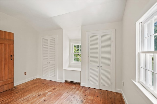 100 E St, South Salem, NY 10590 - unfurnished bedroom with two closets, hardwood / wood-style floors, and lofted ceiling