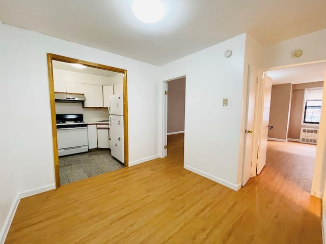 interior space with baseboards and wood finished floors