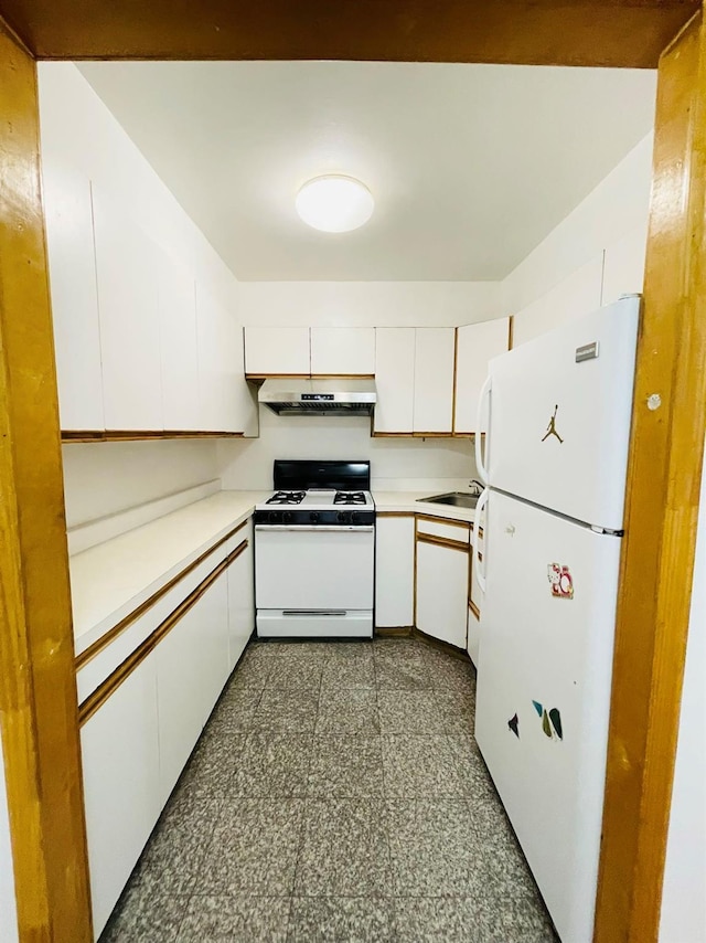 kitchen featuring light countertops, a sink, white cabinets, under cabinet range hood, and white appliances