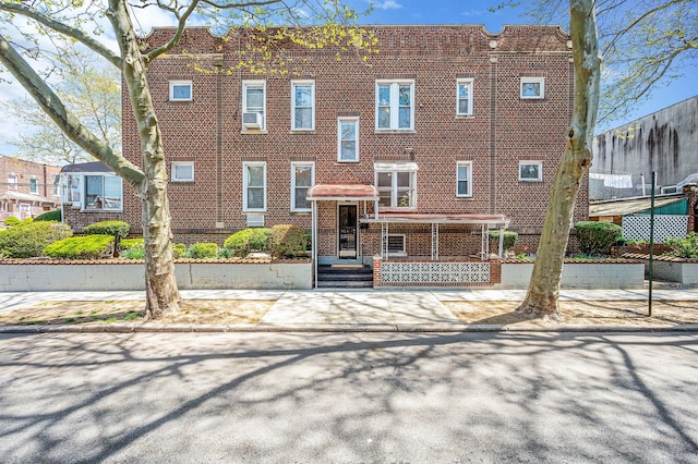 view of front of house with brick siding and cooling unit