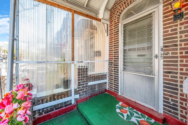 property entrance with brick siding