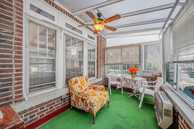 sunroom / solarium featuring a ceiling fan
