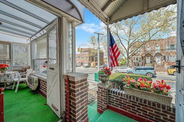 view of patio featuring heating unit and covered porch