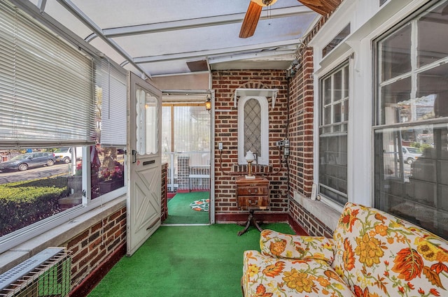 sunroom featuring ceiling fan