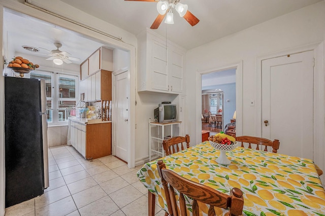 dining room featuring light tile patterned floors, visible vents, and ceiling fan
