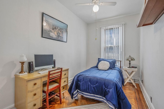bedroom with ceiling fan and baseboards