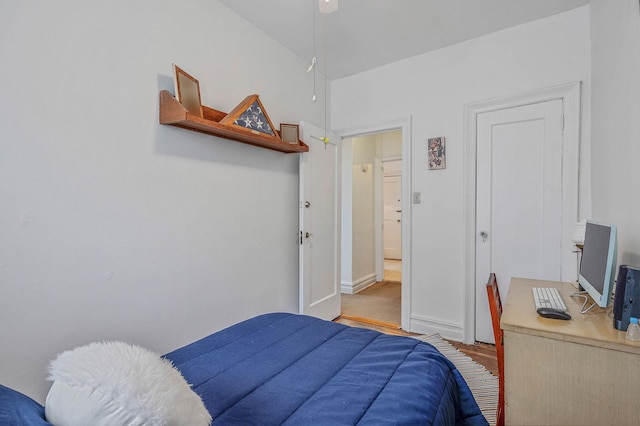 bedroom featuring wood finished floors and baseboards