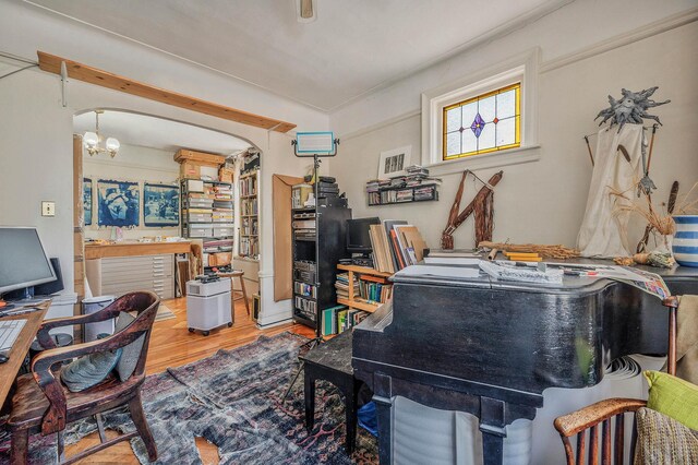 office space with a chandelier and wood finished floors