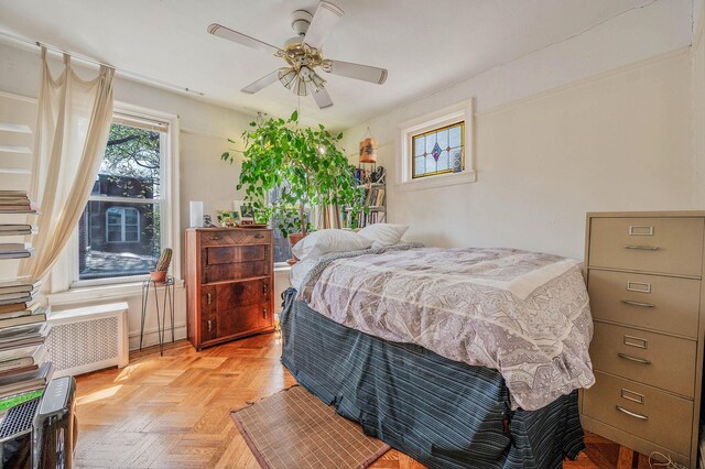 bedroom featuring radiator heating unit and a ceiling fan