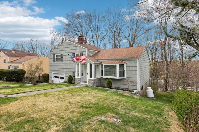 split level home featuring a garage, a front yard, a chimney, and a shingled roof