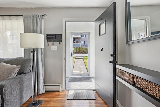 doorway to outside with baseboards and wood finished floors