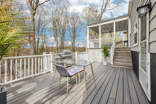 deck with outdoor dining area and grilling area