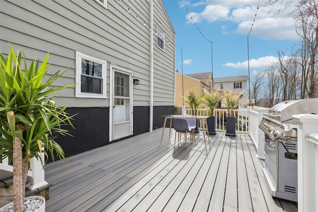 wooden deck featuring area for grilling