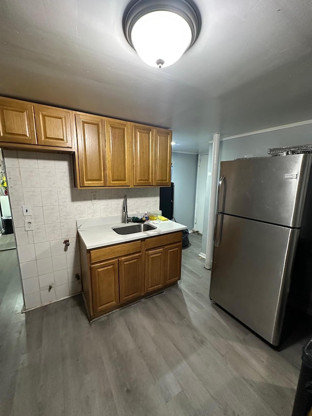1420 Leland Ave, Bronx, NY 10460 - kitchen featuring freestanding refrigerator, light wood-type flooring, light countertops, a sink, and brown cabinets