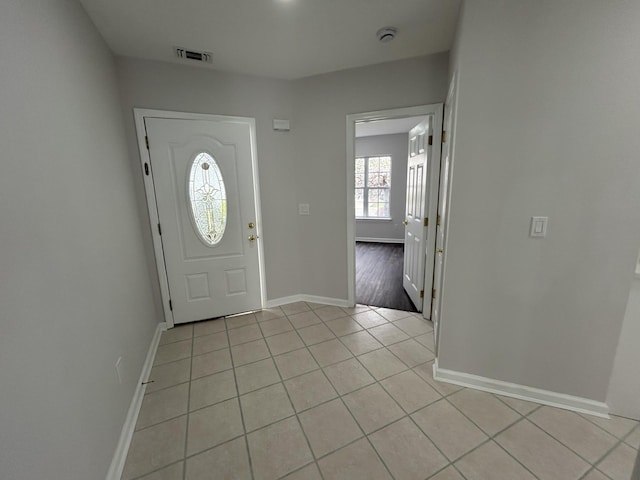 entrance foyer with light tile patterned flooring, baseboards, and visible vents