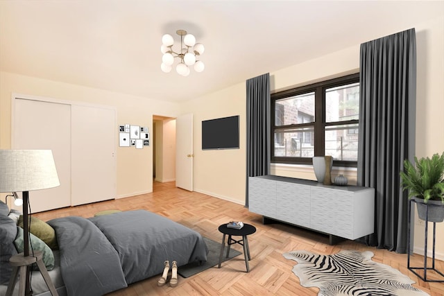 bedroom featuring a closet, baseboards, and an inviting chandelier