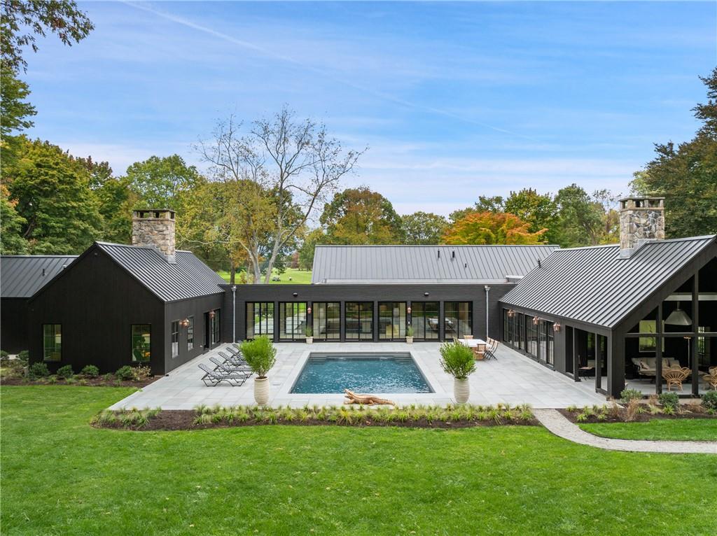 76 E Ridge Rd, Waccabuc, NY 10597 - outdoor pool with a patio, a lawn, and a sunroom