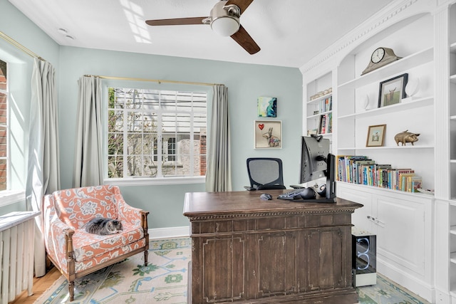 home office with ceiling fan, built in shelves, and baseboards