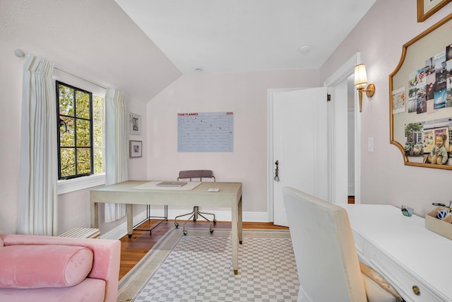 office space featuring tile patterned floors, baseboards, and lofted ceiling