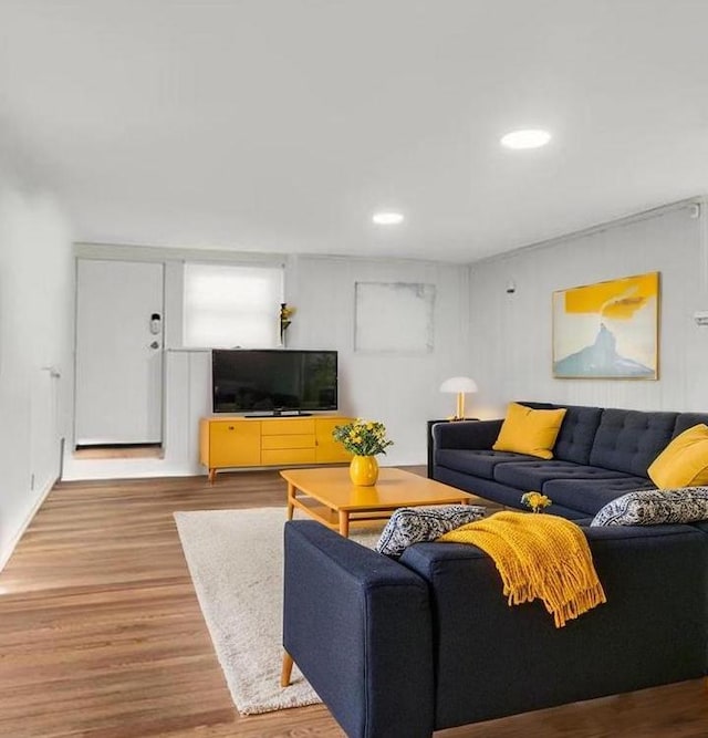 living area with recessed lighting and wood finished floors