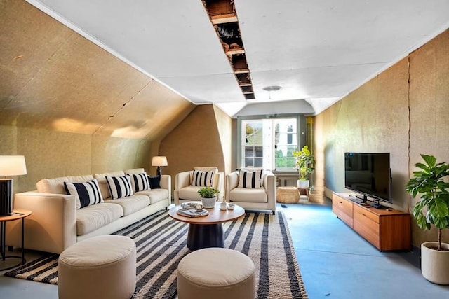 living room featuring concrete flooring and vaulted ceiling