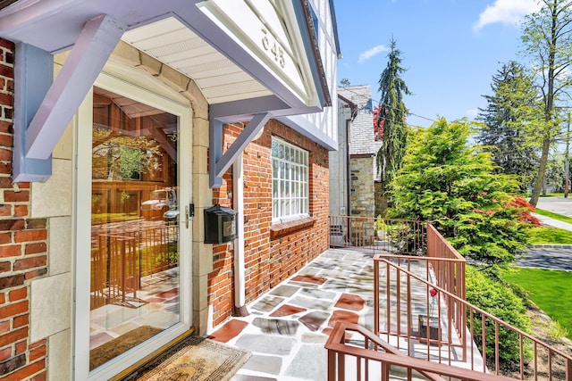 entrance to property featuring brick siding