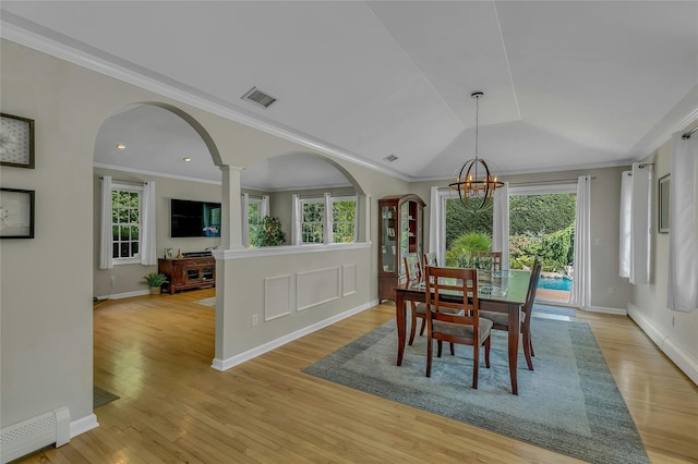 dining room with a baseboard radiator, a healthy amount of sunlight, and a chandelier