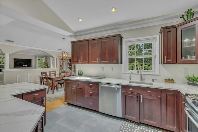 kitchen with vaulted ceiling, visible vents, a sink, light stone countertops, and appliances with stainless steel finishes
