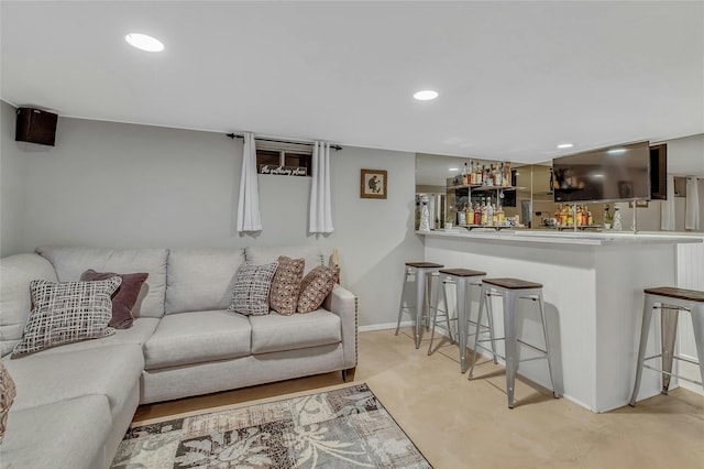 living room featuring recessed lighting and bar