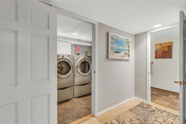 laundry area with baseboards, stone finish floor, washer and dryer, and recessed lighting