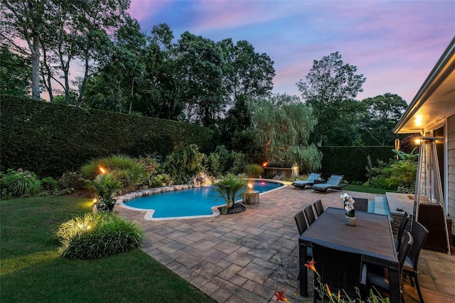 view of swimming pool featuring a yard, a fenced in pool, a fenced backyard, and a patio
