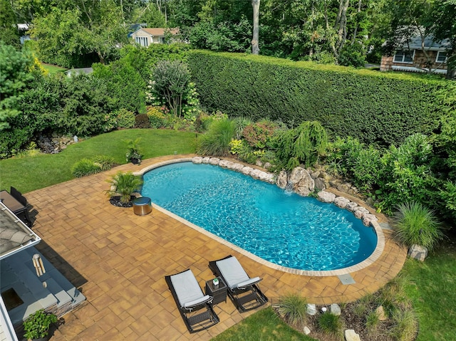 view of pool with a yard, a fenced in pool, and a patio