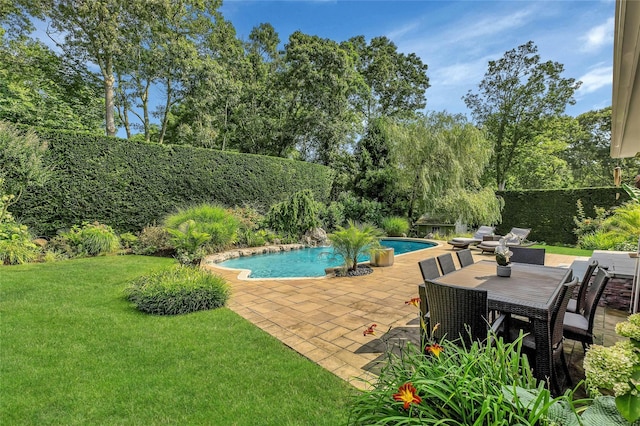 view of swimming pool featuring fence private yard, a fenced in pool, a lawn, and a patio