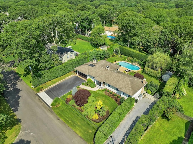drone / aerial view with a wooded view