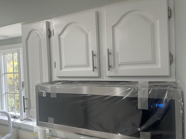 interior details featuring white cabinets