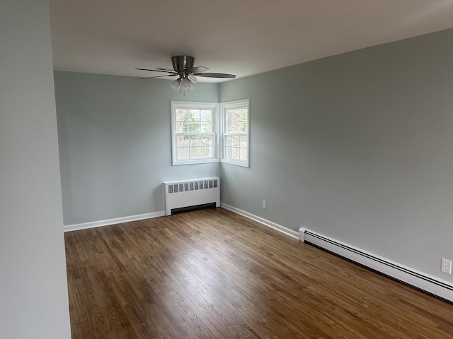 empty room with a baseboard radiator, radiator heating unit, a ceiling fan, wood finished floors, and baseboards