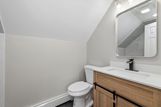 bathroom featuring toilet, baseboard heating, lofted ceiling, and vanity