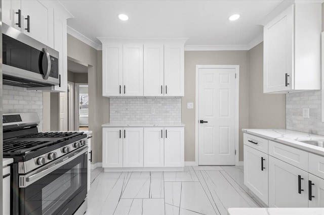 kitchen with crown molding, decorative backsplash, stainless steel appliances, and recessed lighting