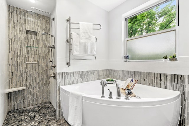 5235 Netherland Ave, Bronx, NY 10471 - full bathroom with tile walls, a garden tub, a tile shower, and wainscoting