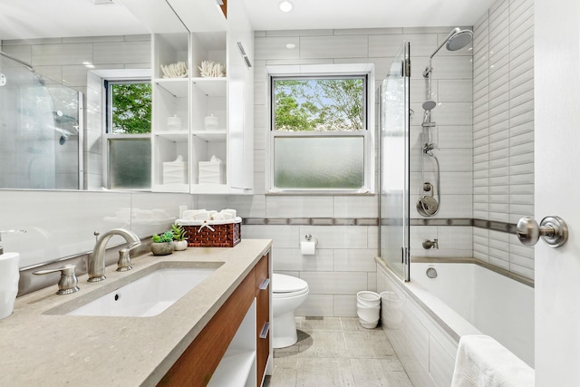 5235 Netherland Ave, Bronx, NY 10471 - full bathroom with vanity, tiled shower / bath, tile walls, and toilet