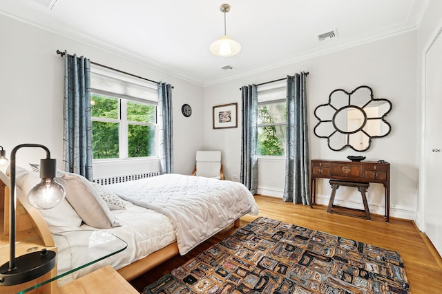 5235 Netherland Ave, Bronx, NY 10471 - bedroom with ornamental molding, light wood-style floors, radiator heating unit, and baseboards