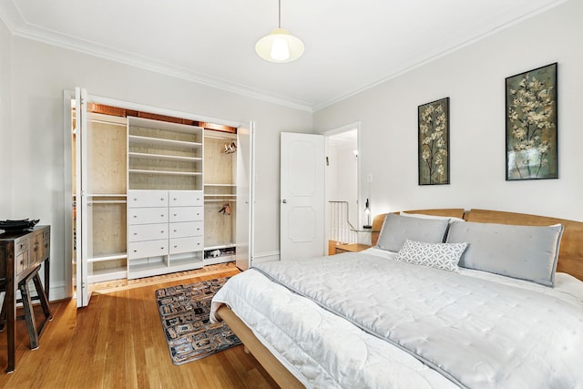 5235 Netherland Ave, Bronx, NY 10471 - bedroom with wood finished floors, crown molding, and a closet