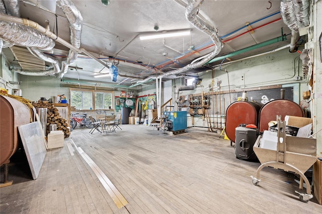 miscellaneous room with hardwood / wood-style flooring and a heating unit