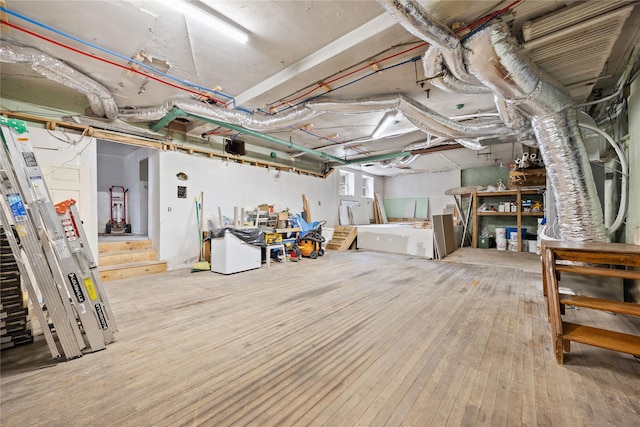 unfinished basement featuring hardwood / wood-style flooring