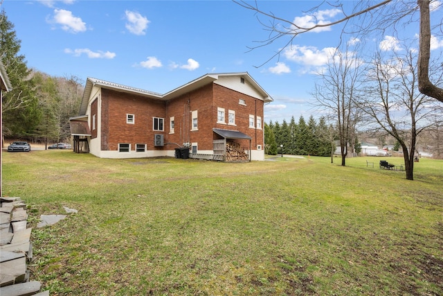 exterior space featuring brick siding and a lawn